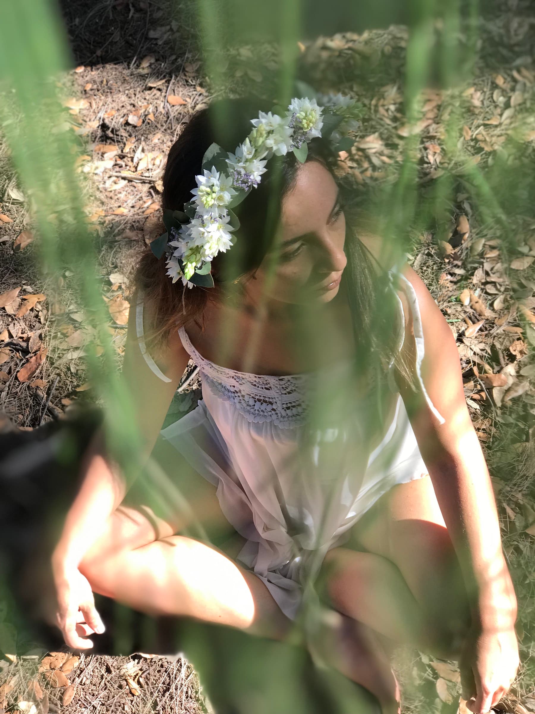 Delicate white flower crown worn in long grass